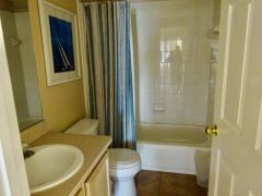 House bathroom with vanity unit, bath, shower over and toilet.