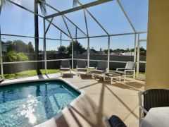 Large south-west facing, fountain pool, with substantial furnished patio area in enclosed screen, surrounded by large grassed gardens.